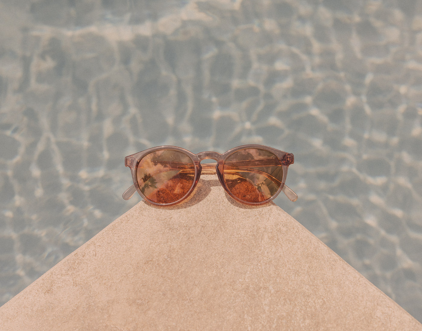 sunski dipsea sunglasses on corner of pool