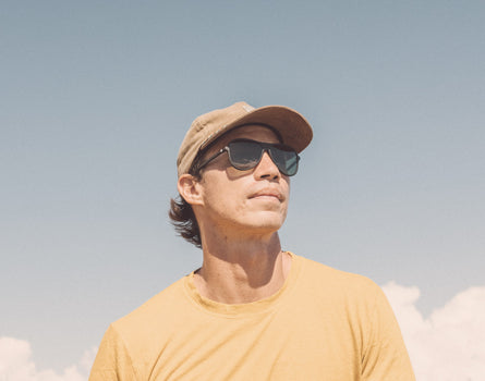guy in a hat wearing sunski foxtrot sunglasses
