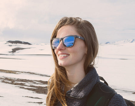 girl in the snow wearing sunski headland sunglasses