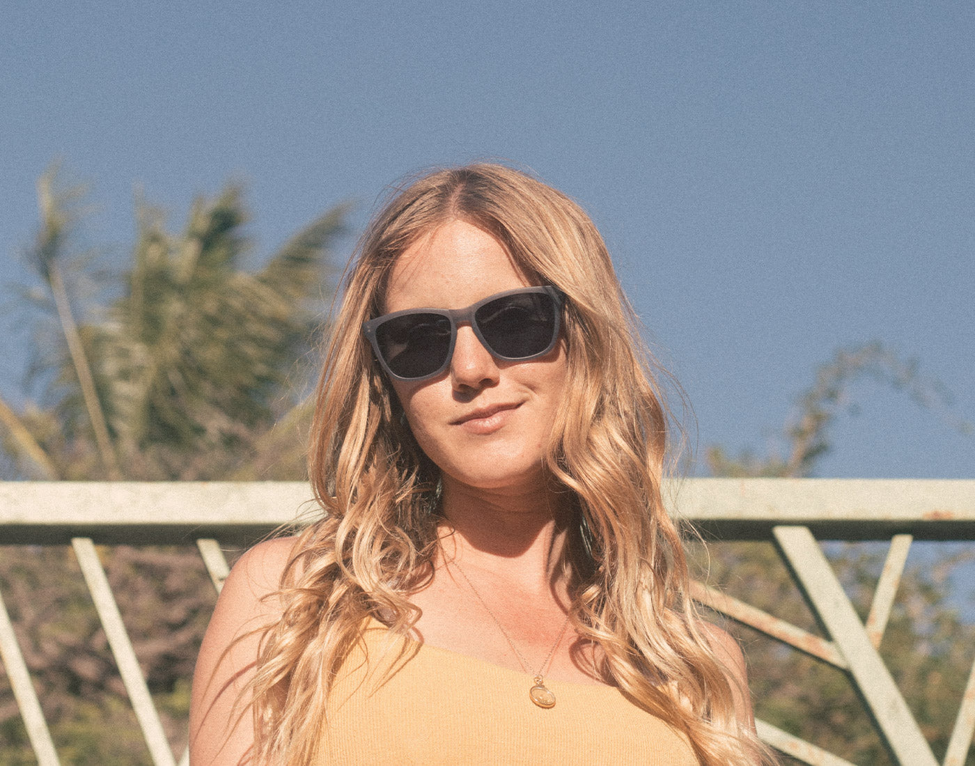 girl smirking wearing sunski headland sunglasses