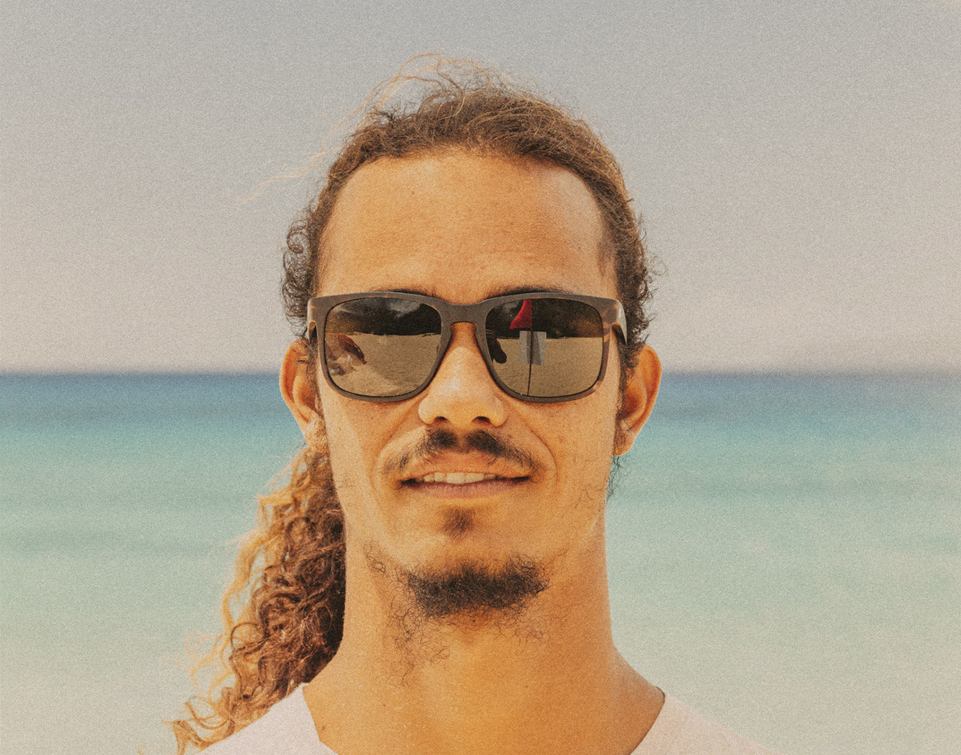 man on beach wearing sunski kiva sunglasses