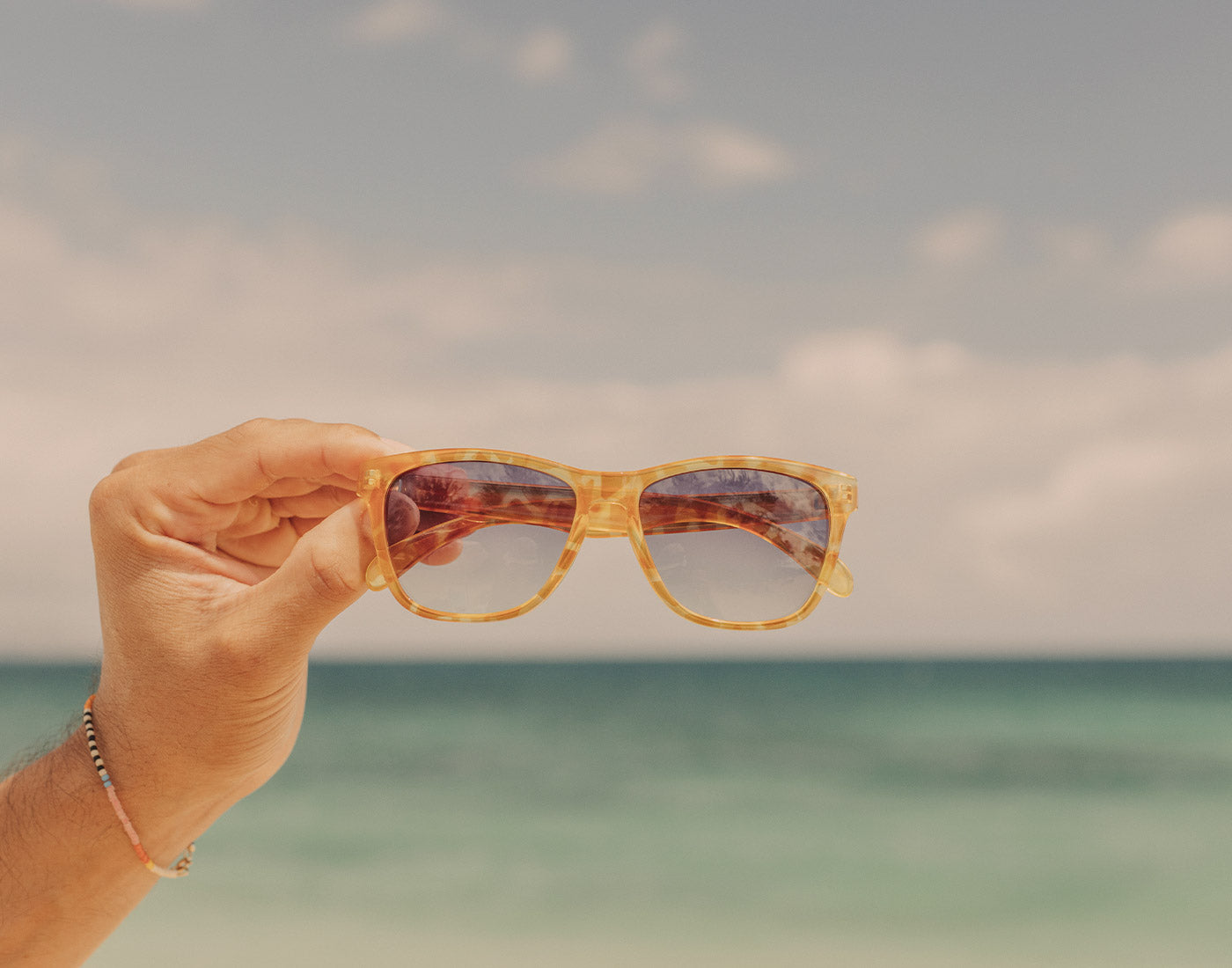 hand holding sunski madrona sunglasses