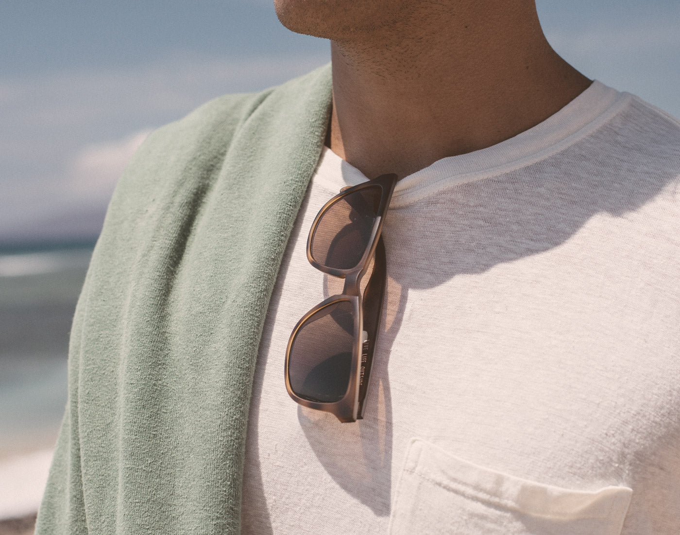 sunski madrona sunglasses hanging on shirt collar