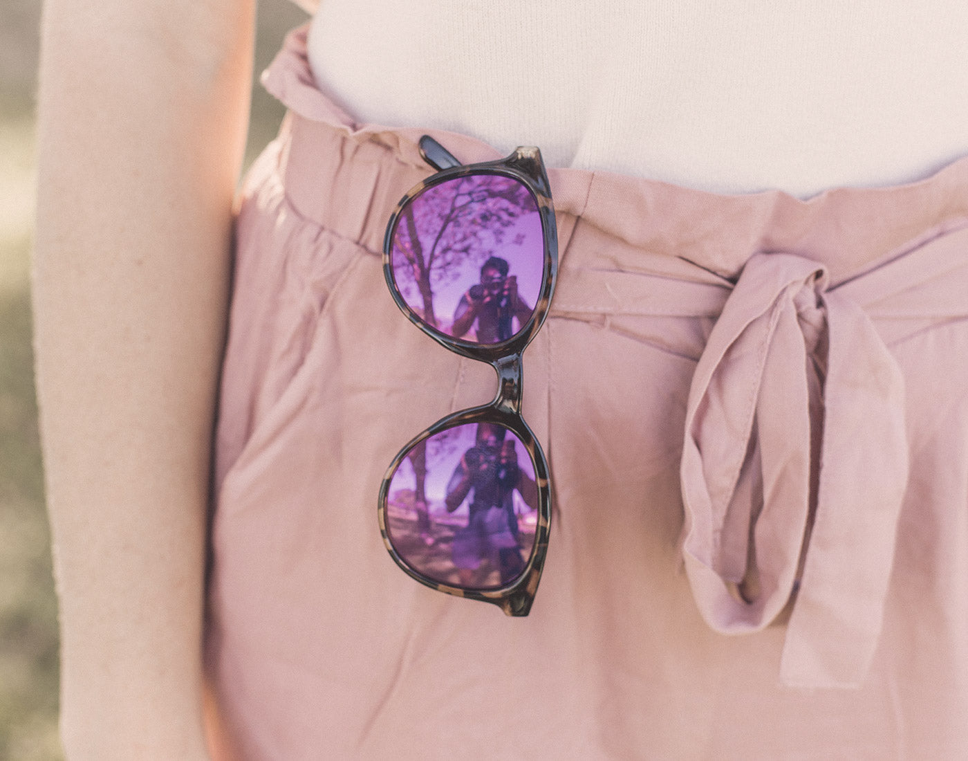 sunski makani sunglasses hanging on shorts waistband