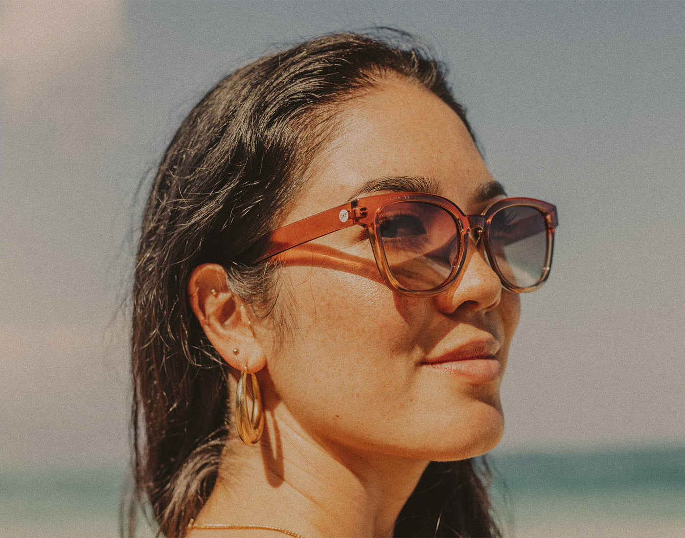 profile shot of woman wearing sunski miho sunglasses