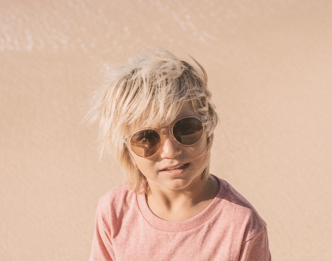 boy in the wind wearing sunski mini dipsea sunglasses