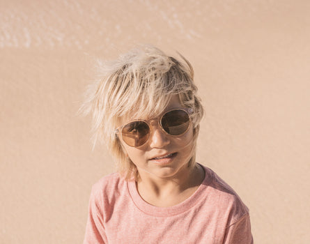 boy in the wind wearing sunski mini dipsea sunglasses