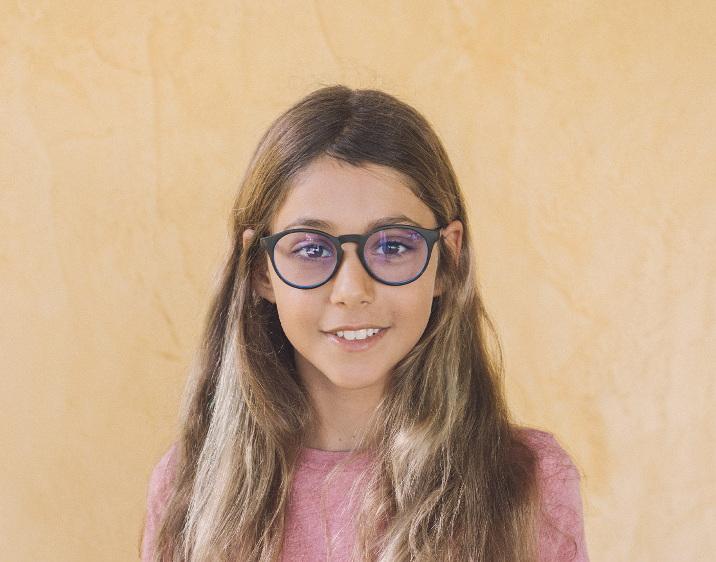 girl wearing sunski mini dipsea bluelight glasses