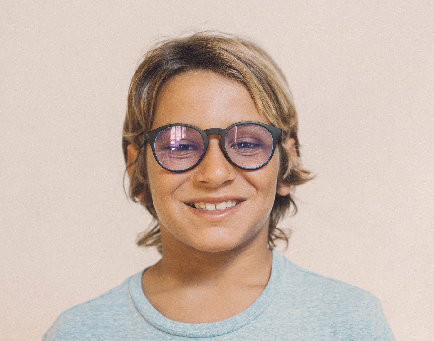 boy wearing sunski mini dipsea bluelight glasses