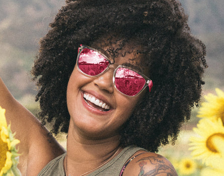 girl laughing wearing sunski original sunglasses