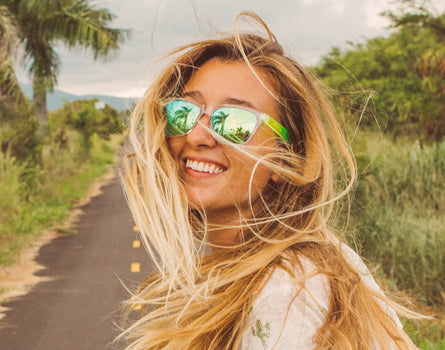 girl turning around wearing sunski original sunglasses