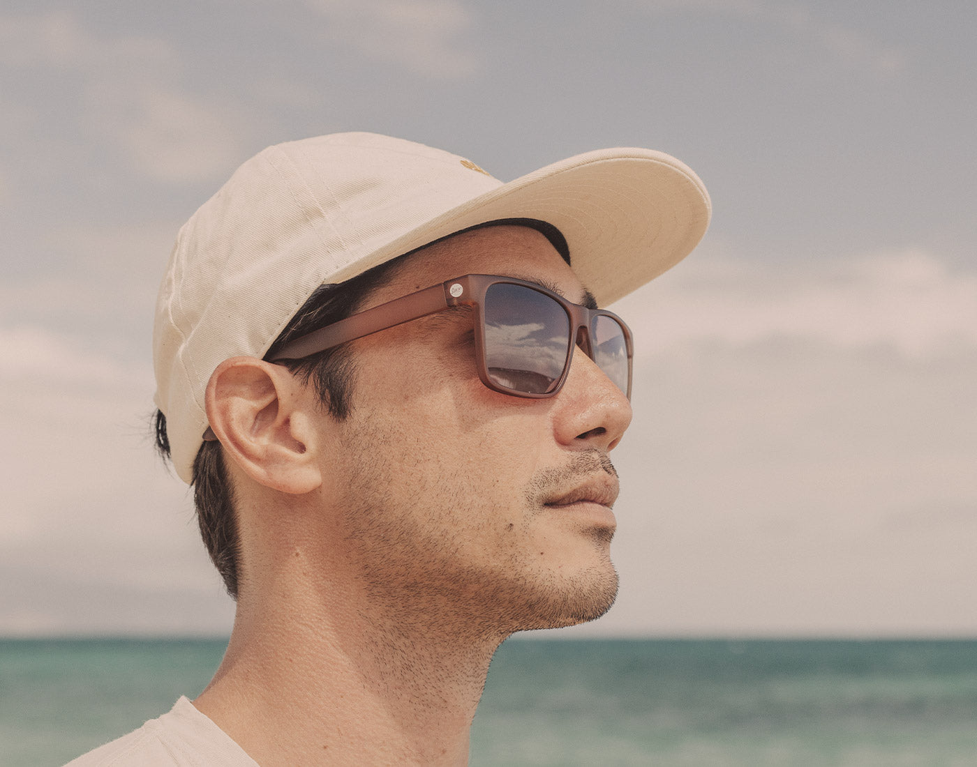 profile of guy in hat wearing sunski puerto sunglasses