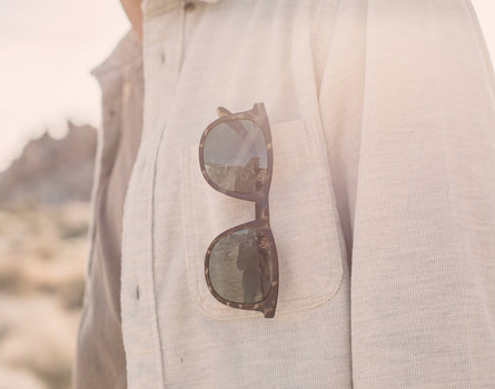 sunski seacliff sunglasses hanging on shirt pocket
