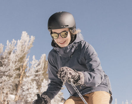girl in helmet skiing wearing sunski tera sunglasses