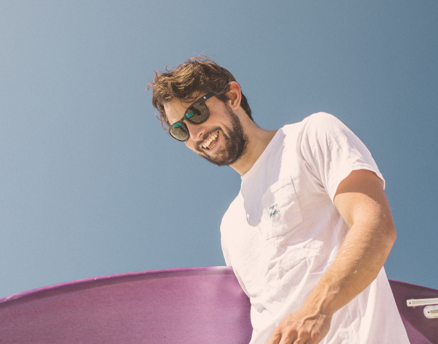 low angle of guy looking down wearing sunski topeka sunglasses