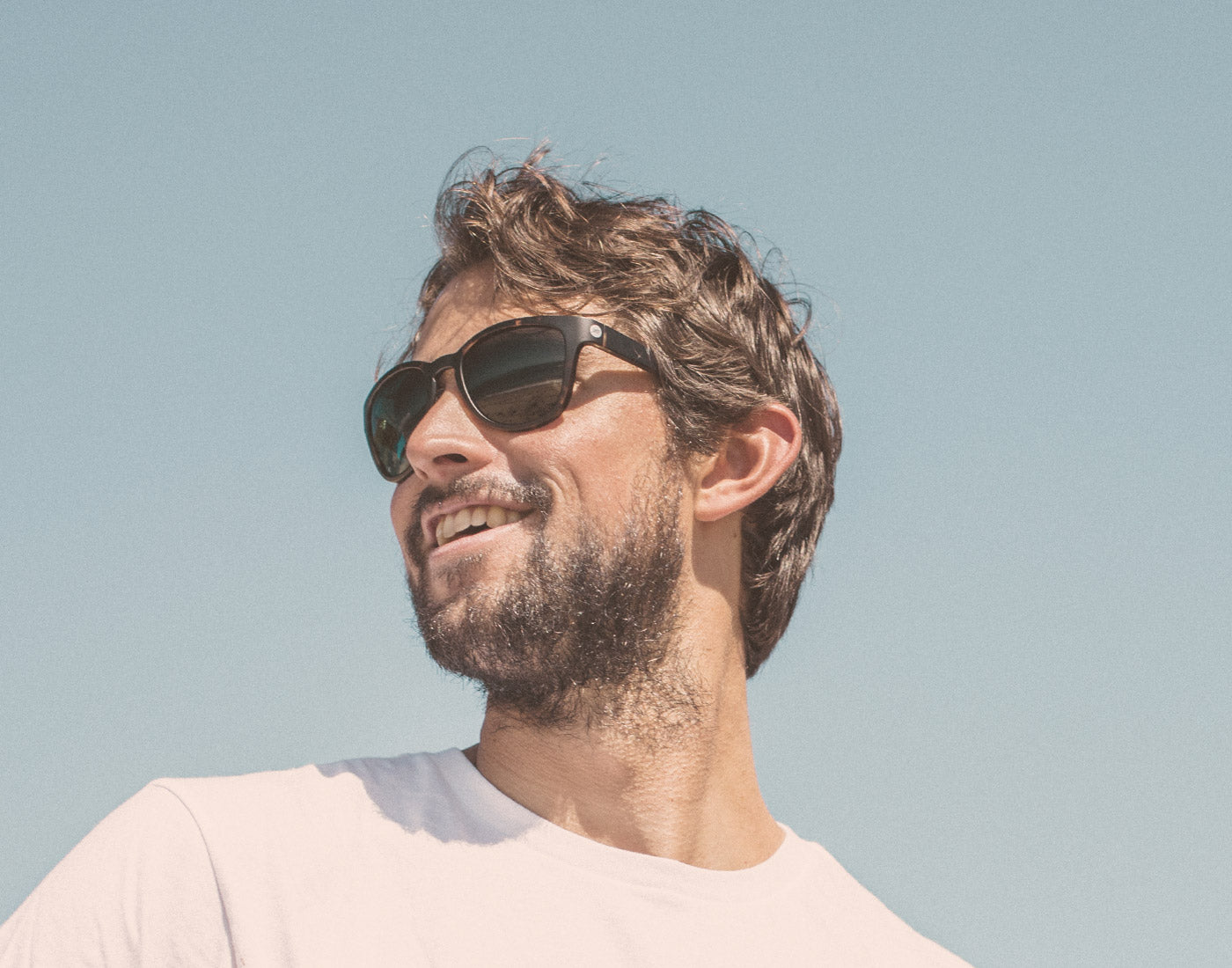 low angle of guy wearing sunski topeka sunglasses