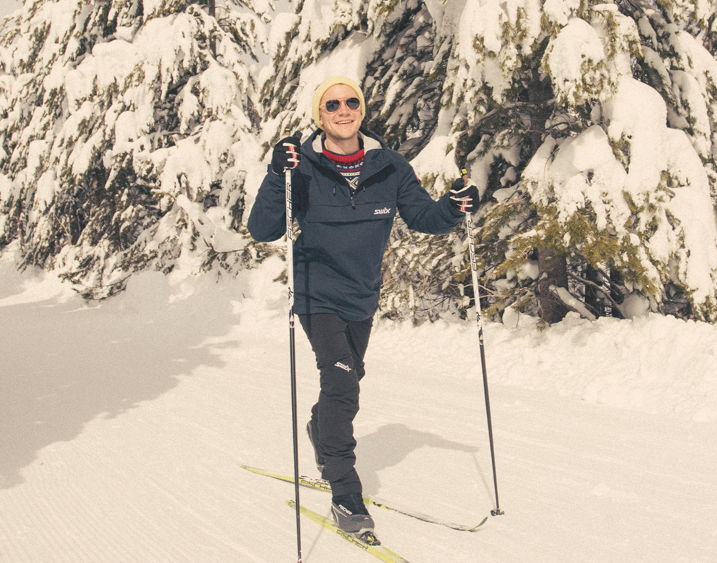 man cross country skiing wearing sunski treeline sunglasses