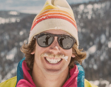 guy in a beanie smiling wearing sunski treeline sunglasses