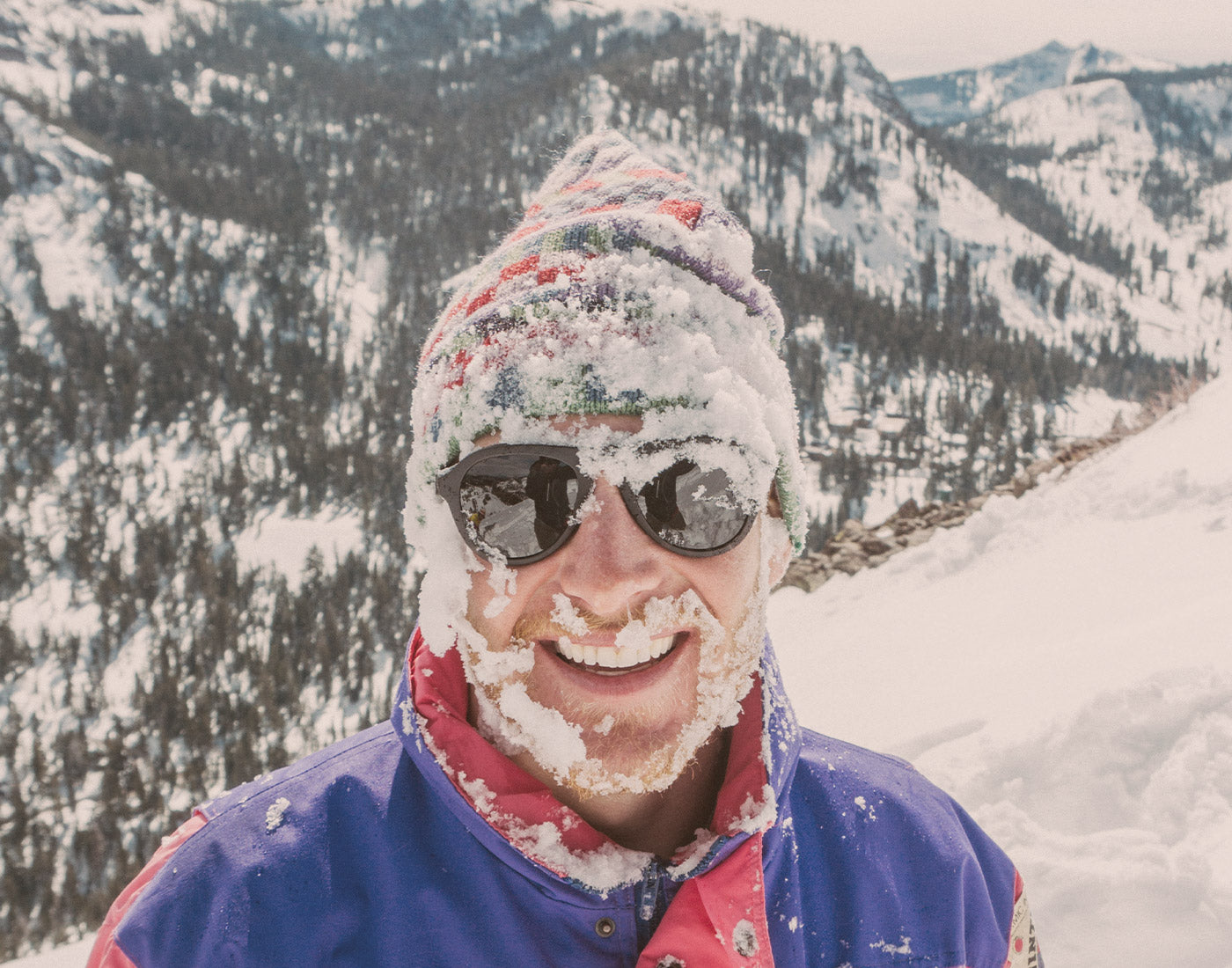 guy covered in snow wearing sunski treeline sunglasses