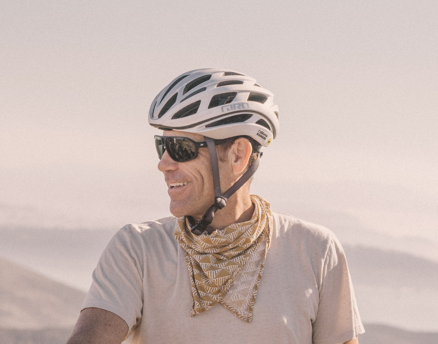 profile of guy in a bike helmet wearing sunski velo sunglasses