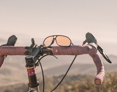 sunski velo sunglasses resting on bike handles