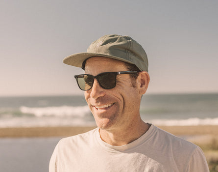 guy in hat smiling wearing sunski ventana sunglasses