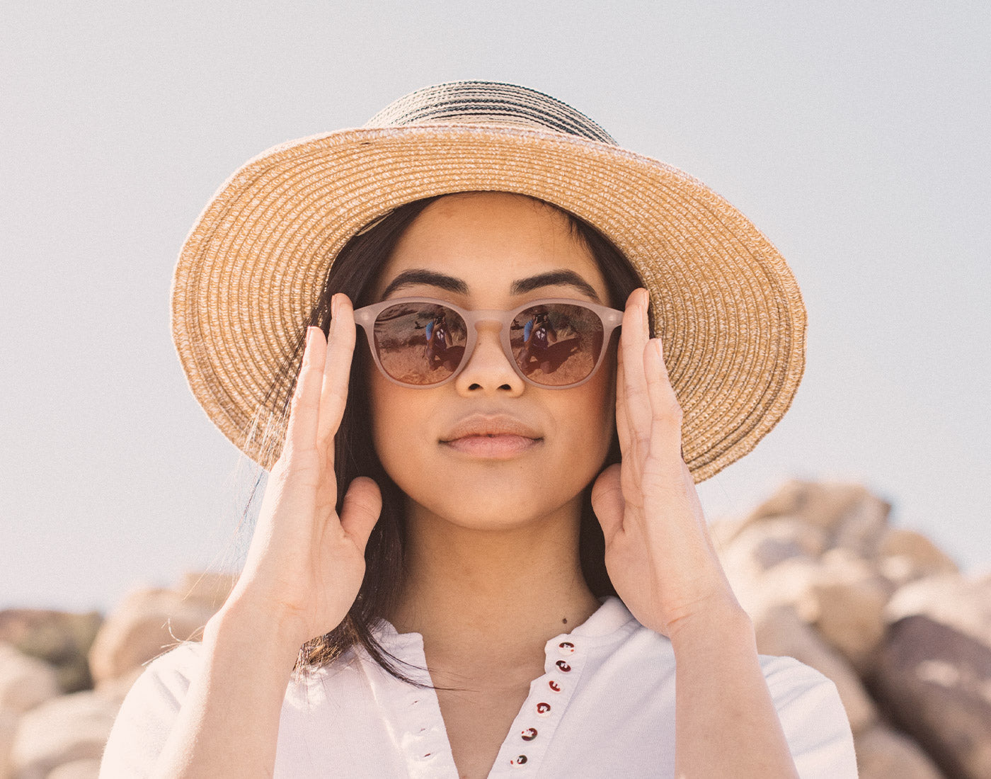 girl in big hat wearing sunski yuba sunglasses