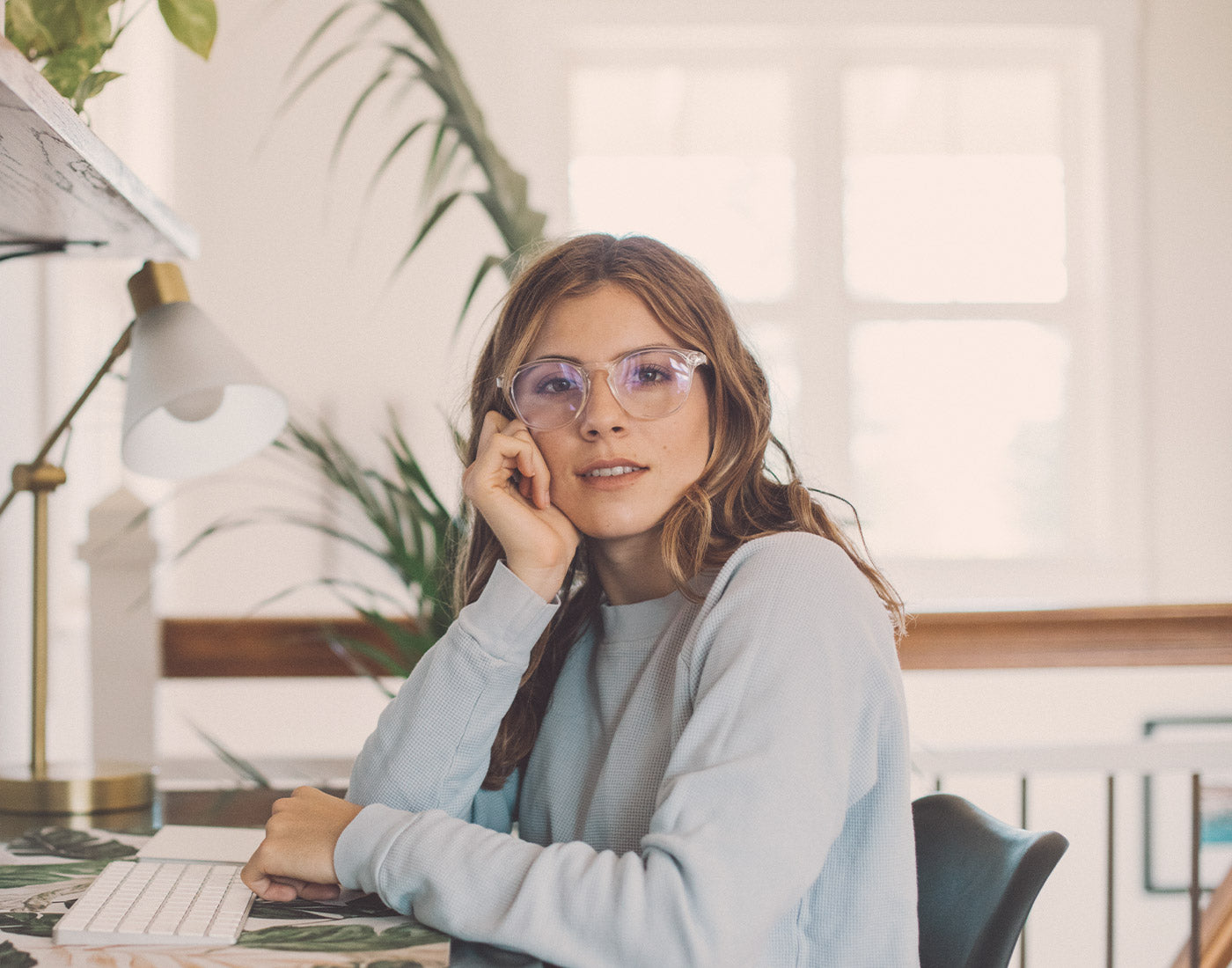girl sitting at desk wearing sunski yuba bluelight glasses