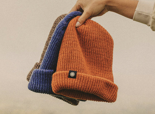 sunski shoulder season beanie hand holding up all three colors