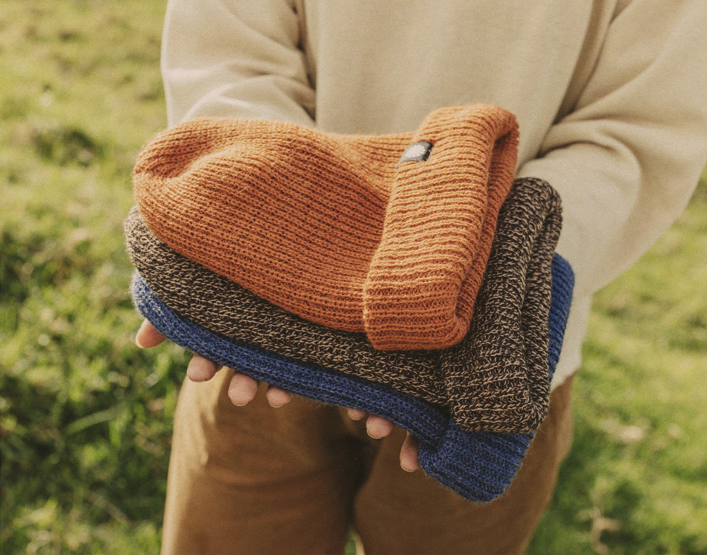 hands holding all three sunski shoulder season beanies