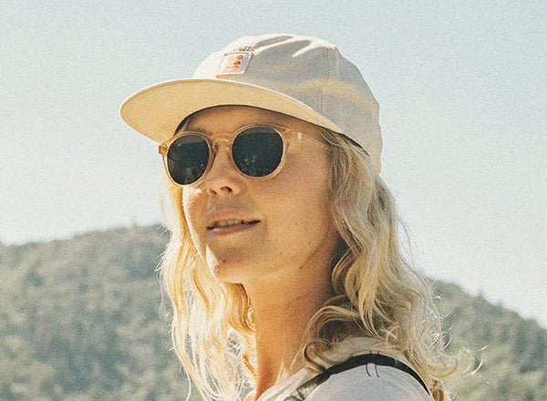 girl wearing sunski sunglasses and sunski sun up hat