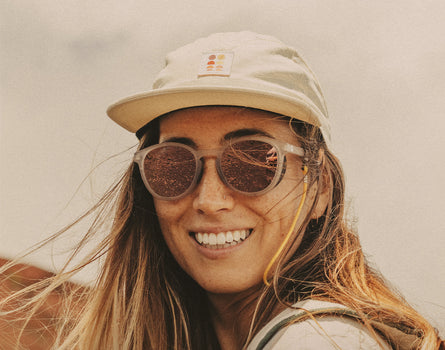 girl smiling wearing sunski sun up hat