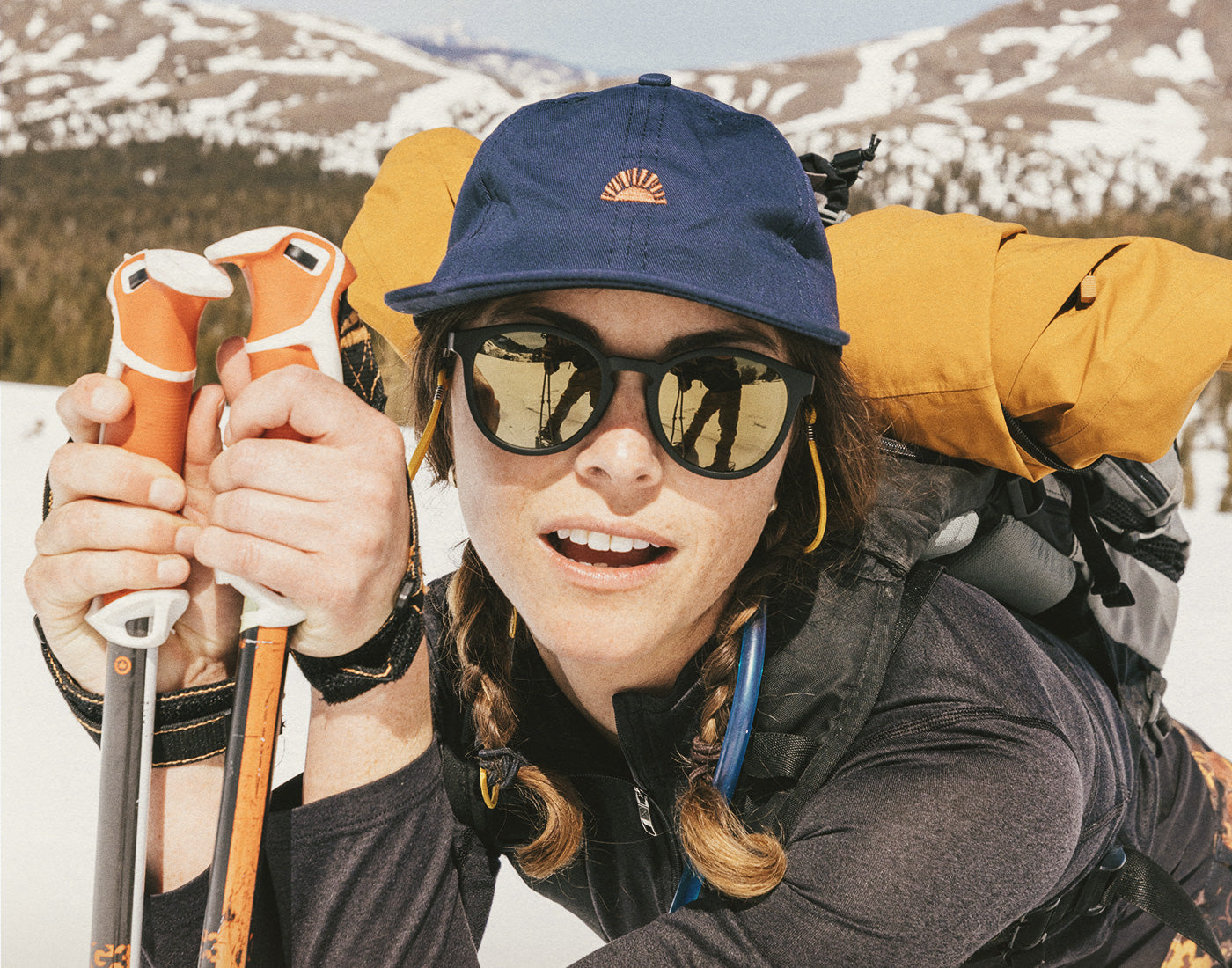 girl backcountry skiing wearing sunski sunburst hat