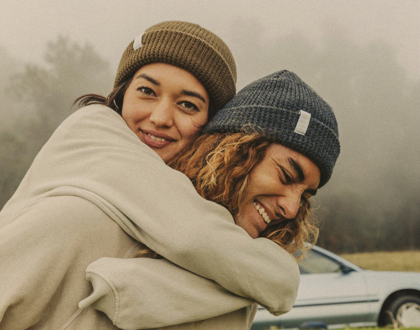 woman on man's back wearing sunski winter sun beanie