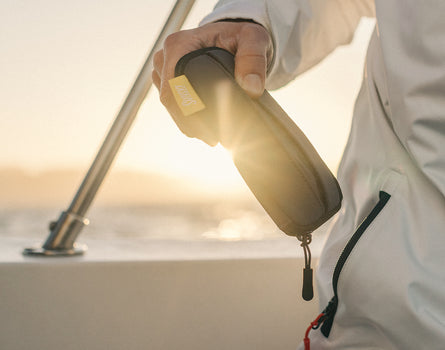 someone holding sunski zipper case in the sun